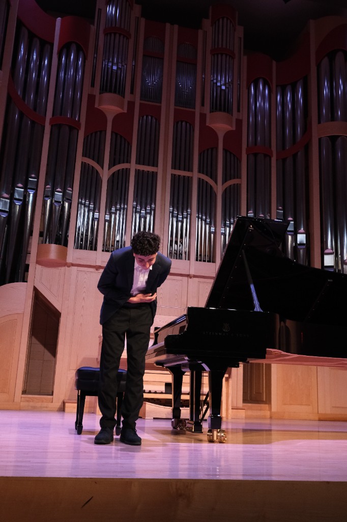 Student bowing after a recital performance