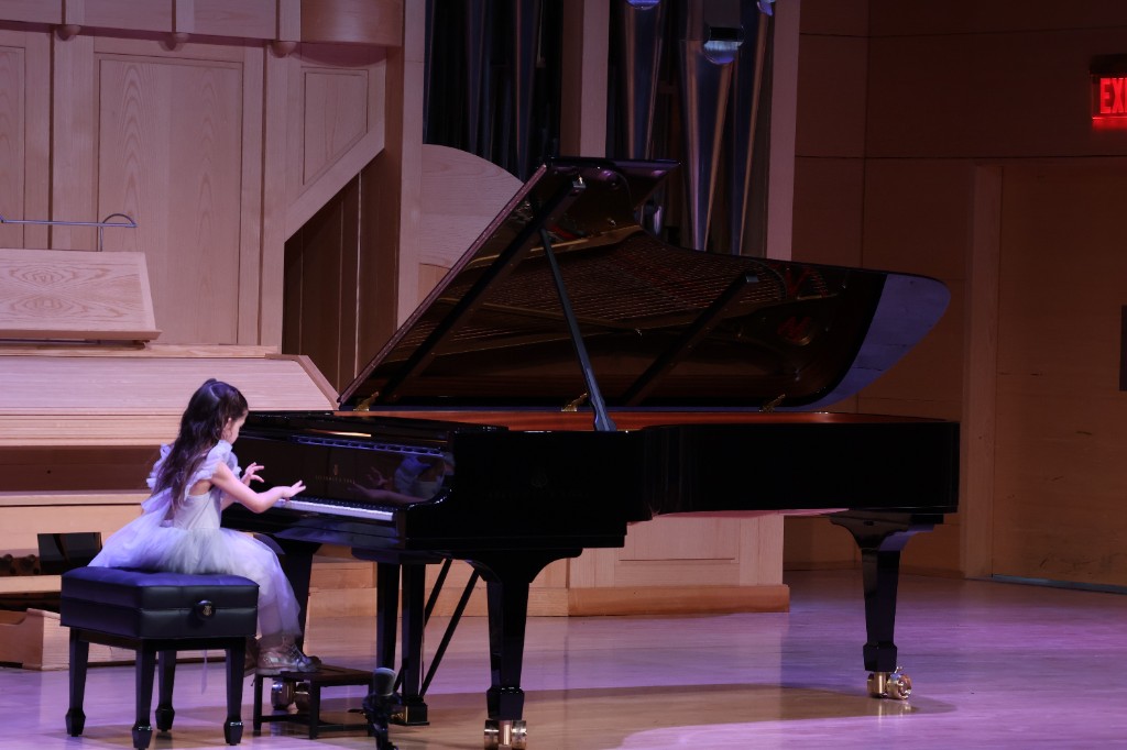 Young student performing at a piano recital